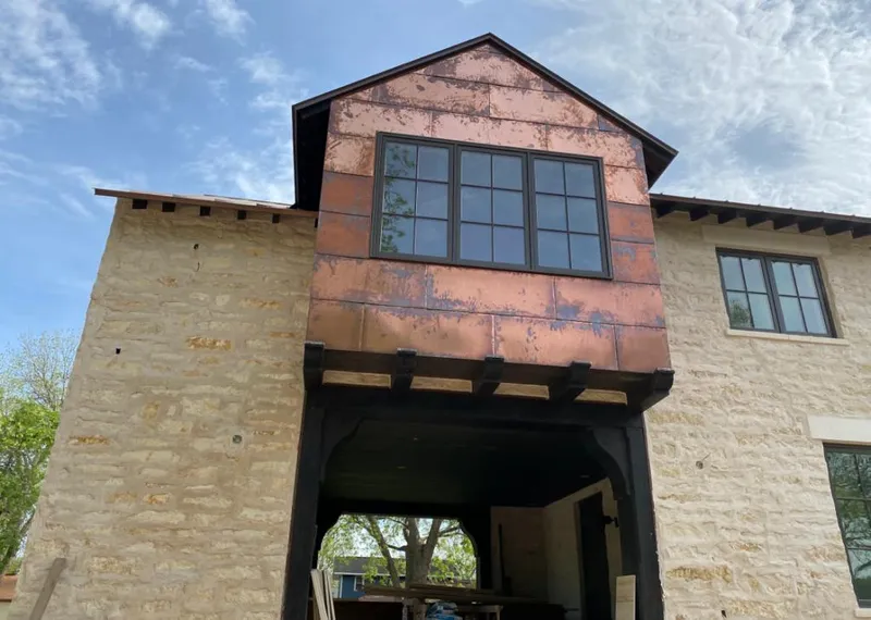 Copper metal panel facade on a stone building for Metal Roof Coating in Laurel